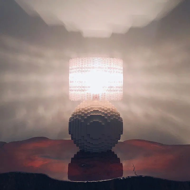 A white Splash of Color lamp glowing warmly and reflected on a glossy surface.